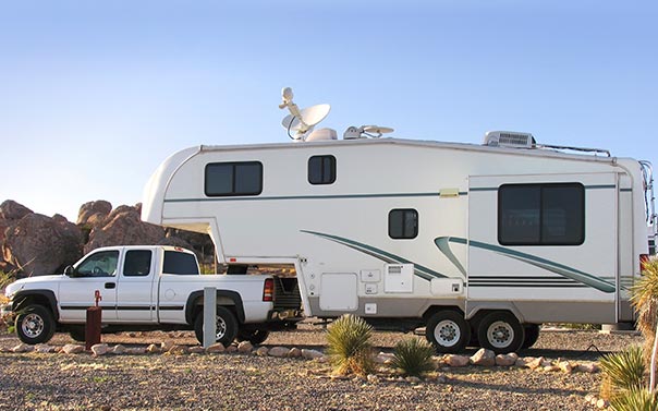 A chevy truck pulling a 5th wheel